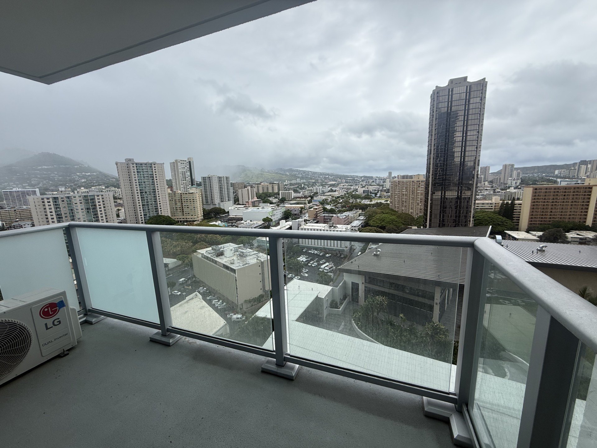 A cityscape viewed from a high-rise building on a cloudy day.